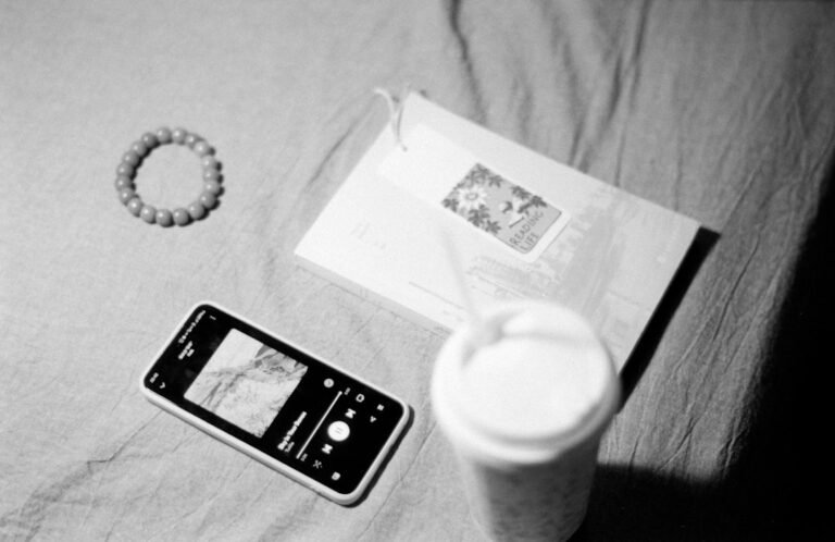 Smartphone and drink on a textured tabletop