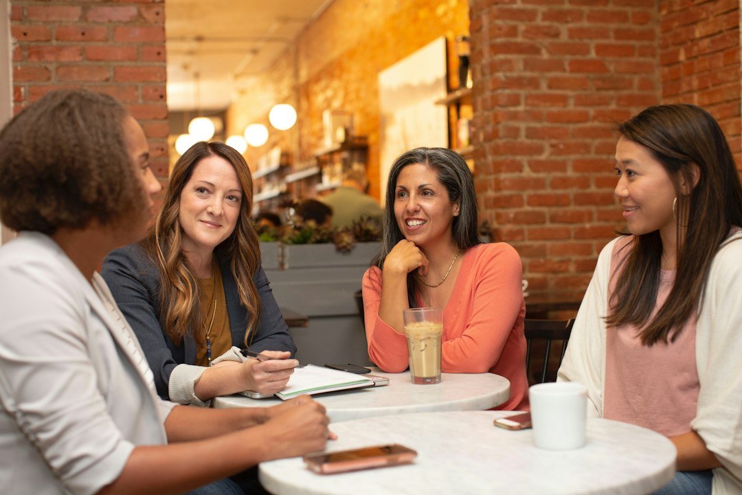 Friends talking together in a relaxed cafe setting