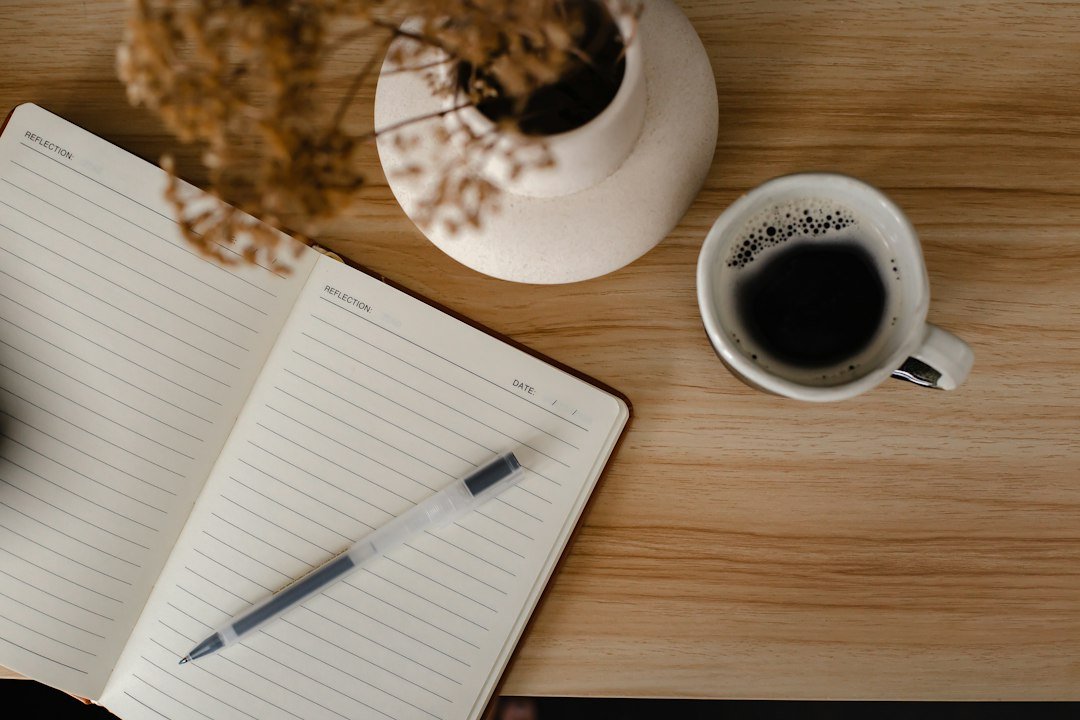Notebook and warm drink arranged for a quiet self-care moment